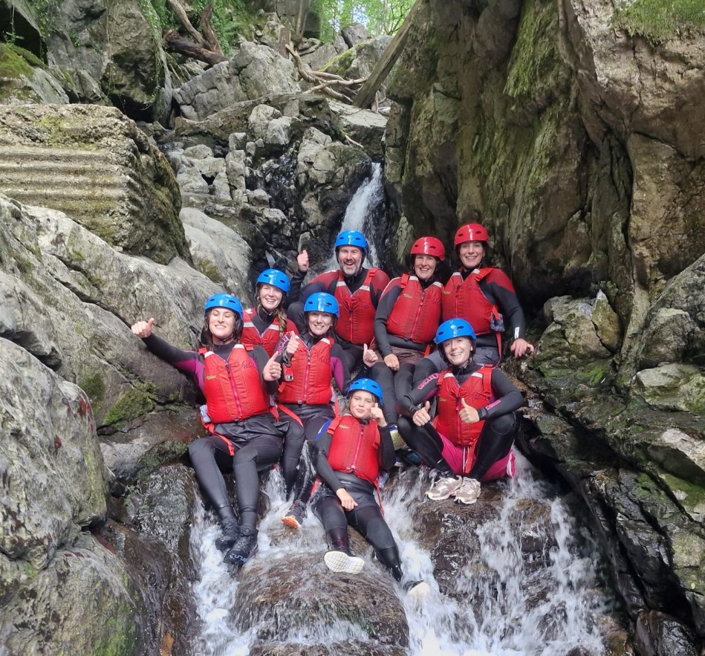 corporate group sitting in a cascading waterfall